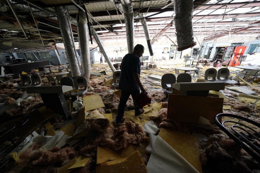 Man walks through destroyed bowling alley after Hurricane Ida